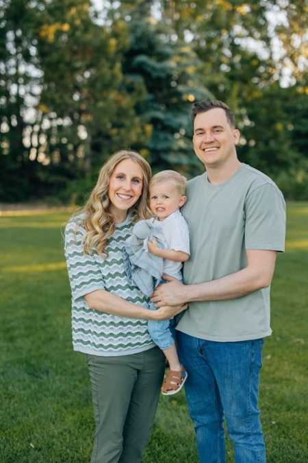 Dr. Mark Braswell poses with his wife and child.